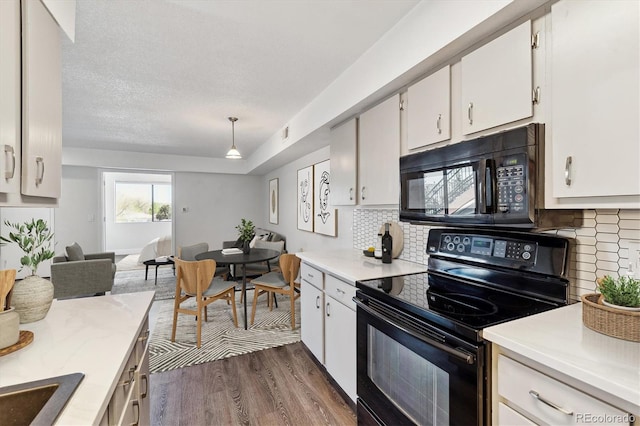 1820 Newland Ct Unit 210, Lakewood, CO 80214 - kitchen featuring black appliances, dark wood-type flooring, light countertops, white cabinets, and a textured ceiling
