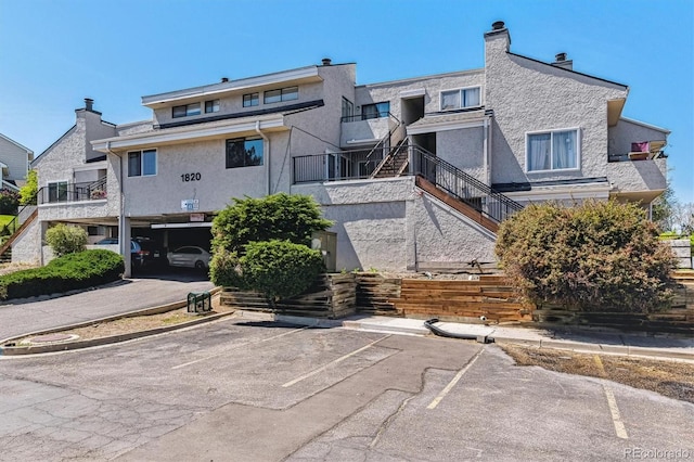 1820 Newland Ct Unit 210, Lakewood, CO 80214 - view of building exterior with stairway and uncovered parking
