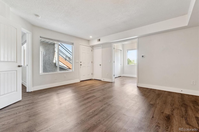 1820 Newland Ct Unit 210, Lakewood, CO 80214 - unfurnished room featuring a textured ceiling, wood finished floors, baseboards, a smoke detector, and recessed lighting