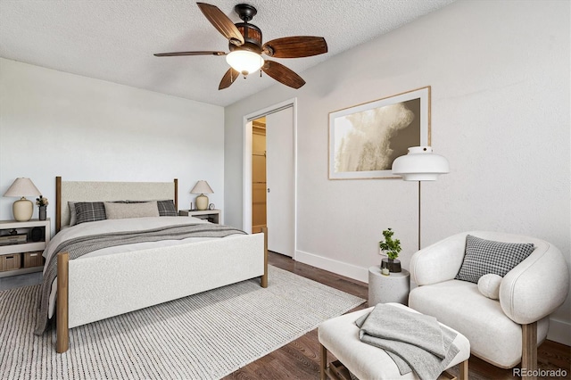 1820 Newland Ct Unit 210, Lakewood, CO 80214 - bedroom with wood finished floors, baseboards, ceiling fan, and a textured ceiling