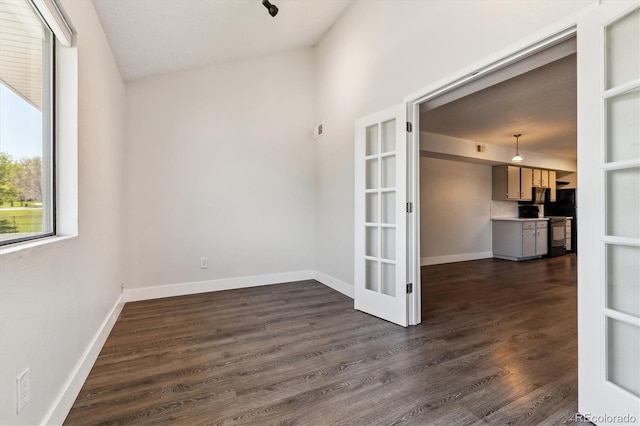 1820 Newland Ct Unit 210, Lakewood, CO 80214 - empty room with french doors, dark wood-style floors, and baseboards