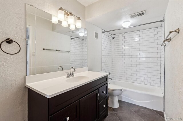 1820 Newland Ct Unit 210, Lakewood, CO 80214 - full bathroom with a textured wall, tile patterned floors, shower / washtub combination, toilet, and vanity