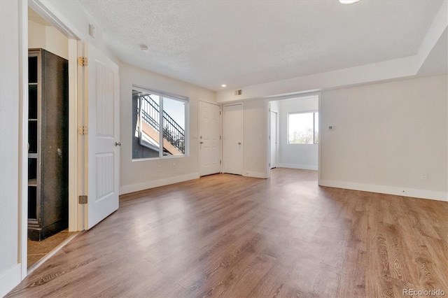 1820 Newland Ct Unit 210, Lakewood, CO 80214 - unfurnished room featuring wood finished floors, baseboards, and a textured ceiling