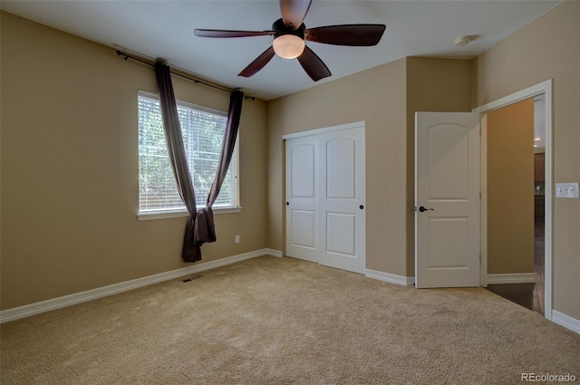 unfurnished bedroom with visible vents, carpet, ceiling fan, and baseboards