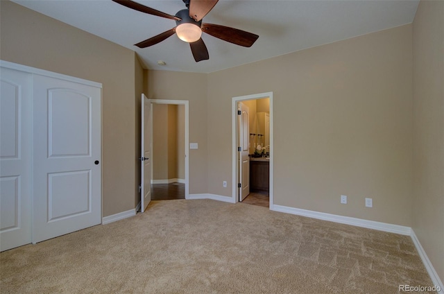 unfurnished bedroom with baseboards, connected bathroom, and light colored carpet