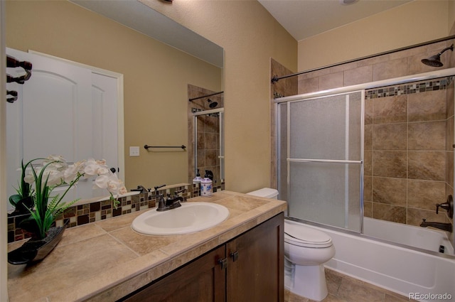 bathroom with toilet, bath / shower combo with glass door, and vanity