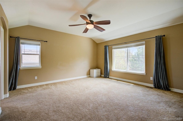 unfurnished room featuring baseboards, a ceiling fan, carpet, and lofted ceiling