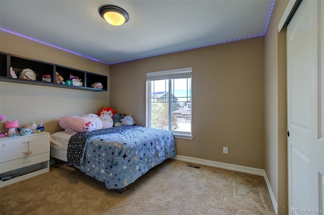 carpeted bedroom featuring visible vents and baseboards