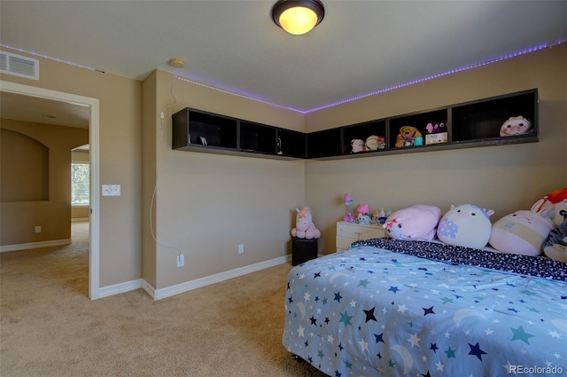 carpeted bedroom with visible vents and baseboards