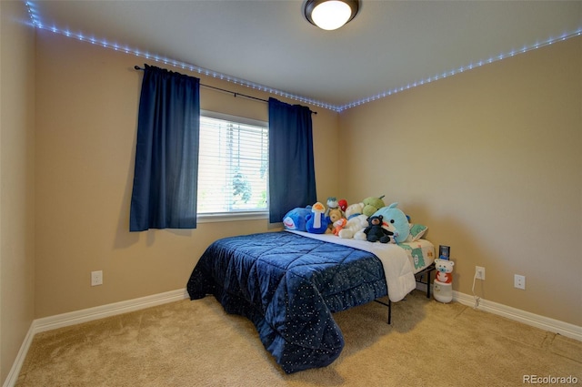 bedroom featuring baseboards and carpet flooring