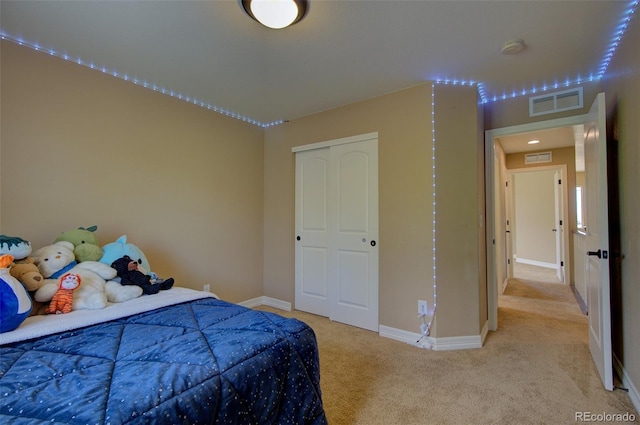 bedroom with baseboards, light carpet, and visible vents