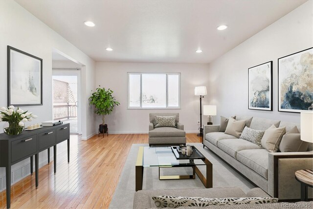 7158 W Roxbury Ave, Littleton, CO 80128 - living room with baseboards, recessed lighting, a healthy amount of sunlight, and light wood-style flooring
