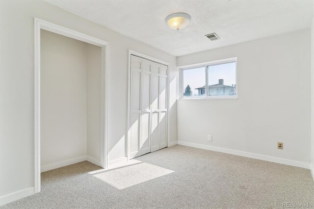 7158 W Roxbury Ave, Littleton, CO 80128 - unfurnished bedroom featuring carpet floors, a closet, visible vents, and baseboards