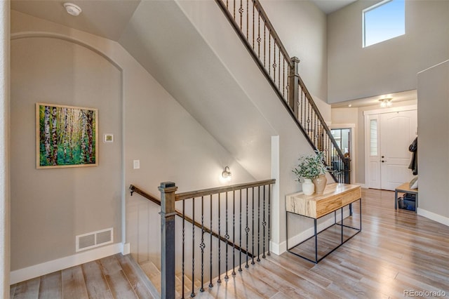 6093 Carmon Dr, Windsor, CO 80550 - staircase featuring visible vents, baseboards, wood finished floors, and vaulted ceiling