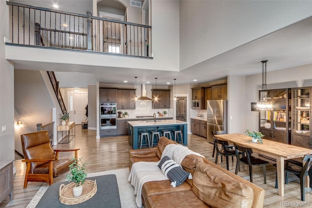 6093 Carmon Dr, Windsor, CO 80550 - living area featuring recessed lighting, a high ceiling, visible vents, and light wood finished floors
