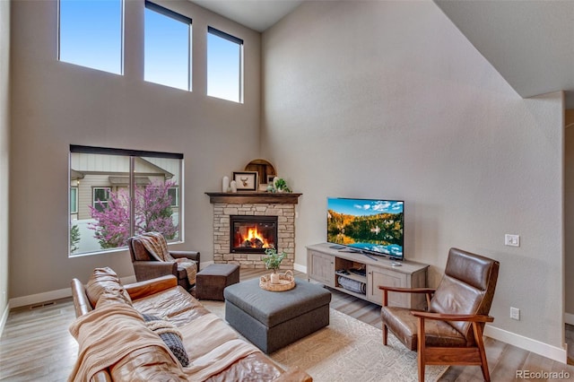 6093 Carmon Dr, Windsor, CO 80550 - living room featuring a fireplace, baseboards, and light wood-style floors