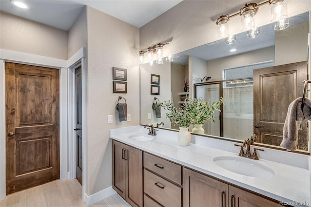 6093 Carmon Dr, Windsor, CO 80550 - bathroom featuring double vanity, a sink, a textured wall, and a shower stall