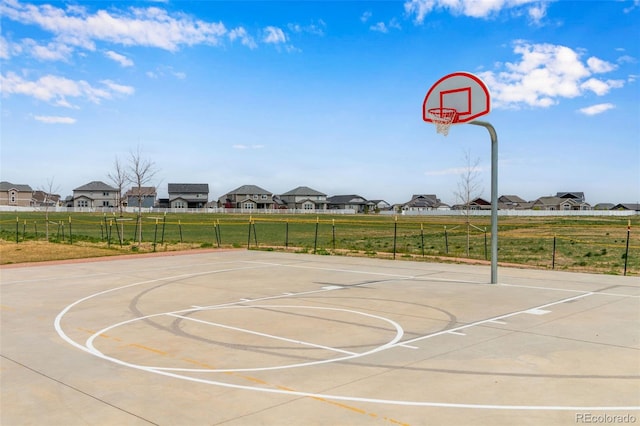 6093 Carmon Dr, Windsor, CO 80550 - view of sport court featuring fence, community basketball court, and a residential view