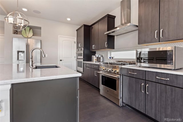 4504 N Picadilly Ct, Aurora, CO 80019 - kitchen featuring wall chimney range hood, stainless steel appliances, dark wood-style flooring, dark brown cabinets, and recessed lighting