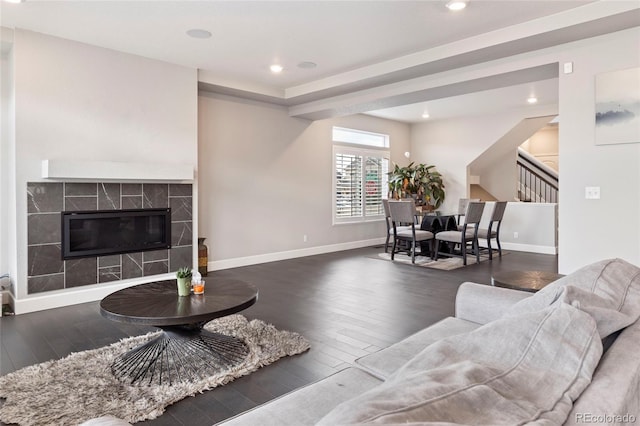 4504 N Picadilly Ct, Aurora, CO 80019 - living area featuring stairs, wood finished floors, a tile fireplace, and recessed lighting
