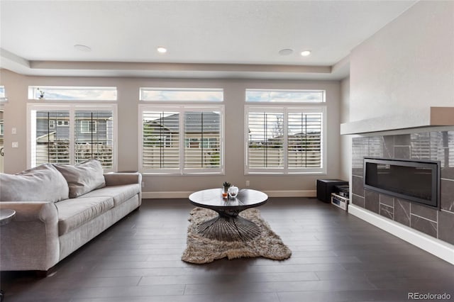 4504 N Picadilly Ct, Aurora, CO 80019 - living area with dark wood finished floors, a fireplace, a raised ceiling, and recessed lighting