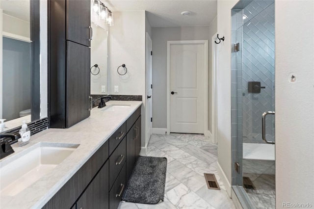 4504 N Picadilly Ct, Aurora, CO 80019 - full bath featuring double vanity, marble look tile flooring, and a shower stall