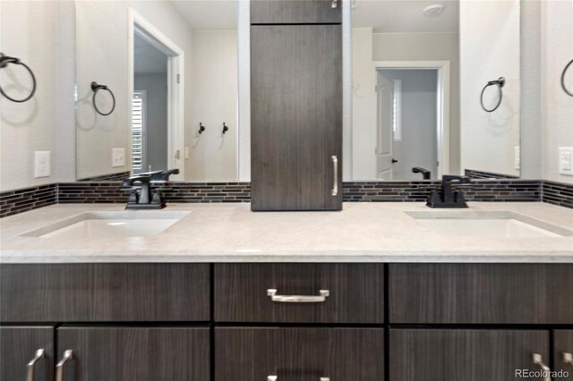 4504 N Picadilly Ct, Aurora, CO 80019 - bathroom featuring backsplash and double vanity