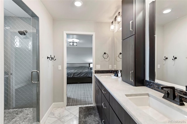 4504 N Picadilly Ct, Aurora, CO 80019 - ensuite bathroom with double vanity, a shower stall, marble finish flooring, and recessed lighting