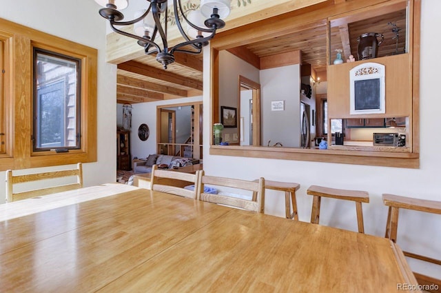 interior space with wooden ceiling, beam ceiling, and an inviting chandelier