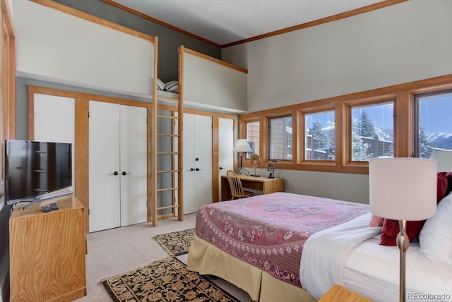 bedroom featuring a high ceiling, crown molding, and light colored carpet