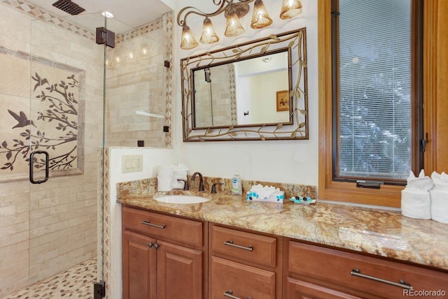 bathroom with a stall shower, visible vents, and vanity