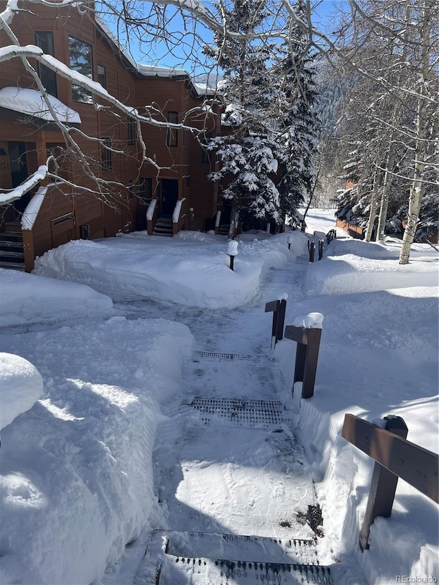 snowy yard with a garage