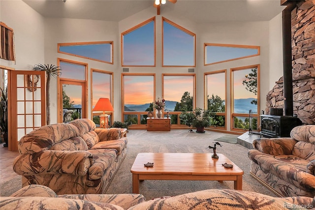 13954 Pine Country Ln, Conifer, CO 80433 - living area with a wood stove, carpet floors, and a high ceiling