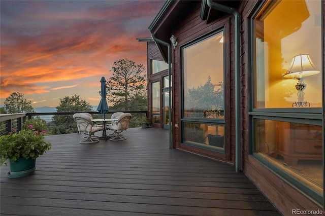 13954 Pine Country Ln, Conifer, CO 80433 - deck at dusk featuring outdoor dining space