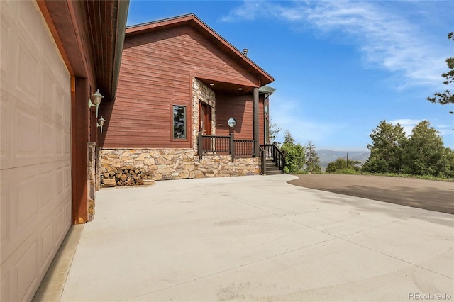 13954 Pine Country Ln, Conifer, CO 80433 - view of side of property with stone siding and a mountain view