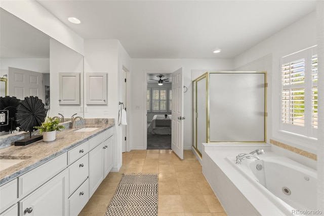 ensuite bathroom with plenty of natural light, a shower stall, ceiling fan, double vanity, and recessed lighting