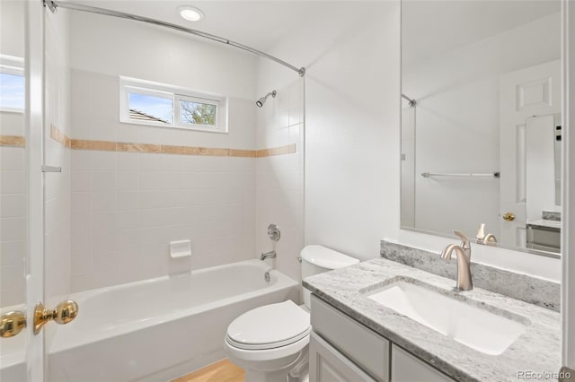 bathroom featuring plenty of natural light, toilet, tub / shower combination, and vanity