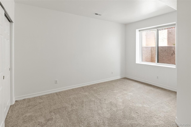 unfurnished bedroom with carpet flooring, a closet, and baseboards