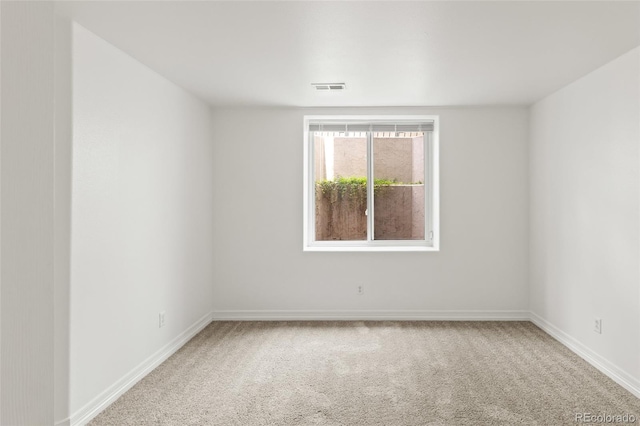 unfurnished room with carpet flooring and baseboards