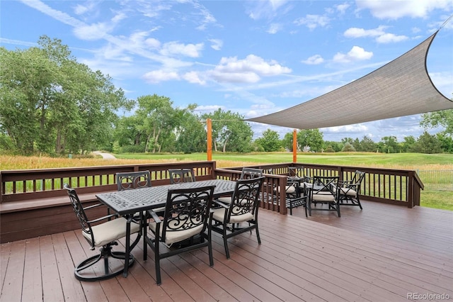 16862 W 65th Cir, Arvada, CO 80007 - wooden terrace with outdoor dining space, a yard, and view of wooded area