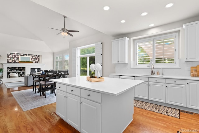 16862 W 65th Cir, Arvada, CO 80007 - kitchen with light wood-style floors, a ceiling fan, a center island, vaulted ceiling, and recessed lighting