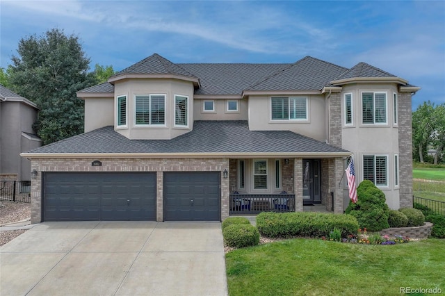 16862 W 65th Cir, Arvada, CO 80007 - view of front facade with concrete driveway, covered porch, stucco siding, and a garage
