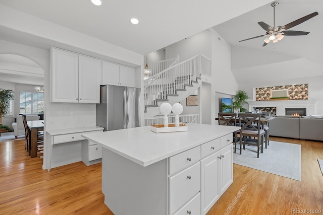 16862 W 65th Cir, Arvada, CO 80007 - kitchen with freestanding refrigerator, white cabinetry, a ceiling fan, light wood-type flooring, and light countertops