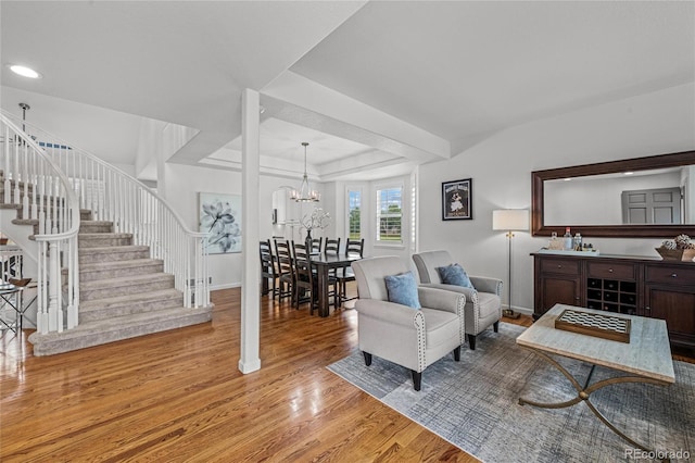 16862 W 65th Cir, Arvada, CO 80007 - living room featuring wood finished floors, stairs, a chandelier, recessed lighting, and a tray ceiling