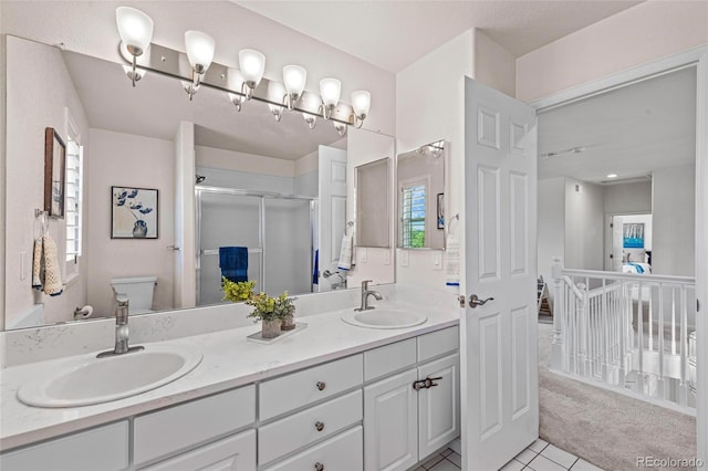 16862 W 65th Cir, Arvada, CO 80007 - bathroom with double vanity, a stall shower, and tile patterned floors