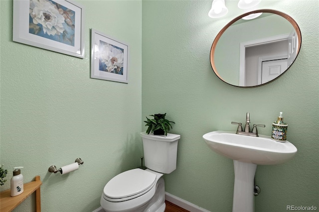 16862 W 65th Cir, Arvada, CO 80007 - half bathroom featuring toilet and wood finished floors