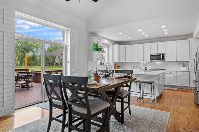 16862 W 65th Cir, Arvada, CO 80007 - dining space featuring lofted ceiling, light wood finished floors, and recessed lighting
