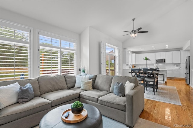 16862 W 65th Cir, Arvada, CO 80007 - living room with light wood-type flooring, a ceiling fan, and vaulted ceiling
