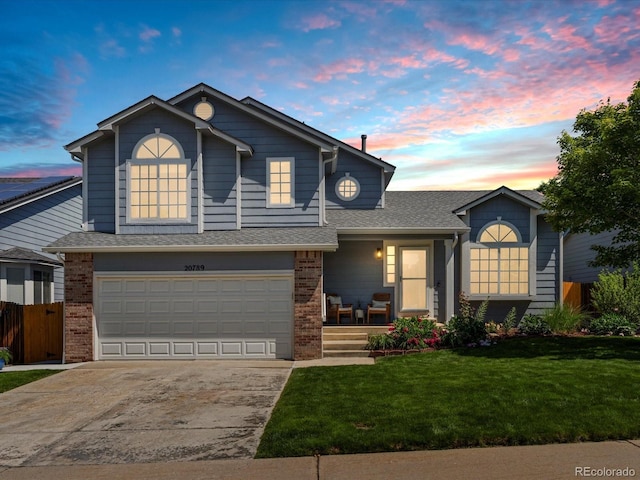 20789 E Princeton Pl, Aurora, CO 80013 - view of front facade with brick siding, driveway, an attached garage, covered porch, and roof with shingles