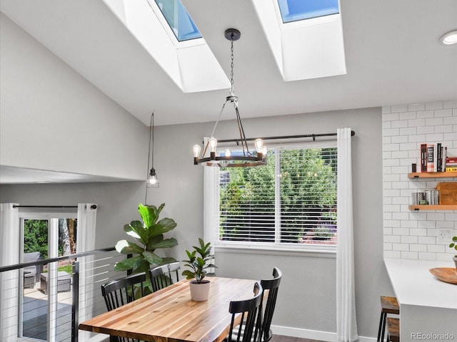 20789 E Princeton Pl, Aurora, CO 80013 - dining room featuring a skylight, a chandelier, baseboards, and lofted ceiling